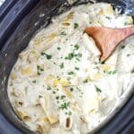 Creamy slow cooker chicken Alfredo in the crock.