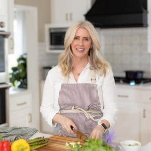 Erin Henry cutting vegetables in her kitchen.