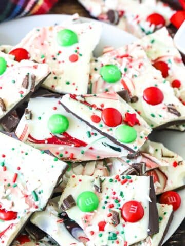 Plate of Christmas Bark with M&Ms and sprinkles.