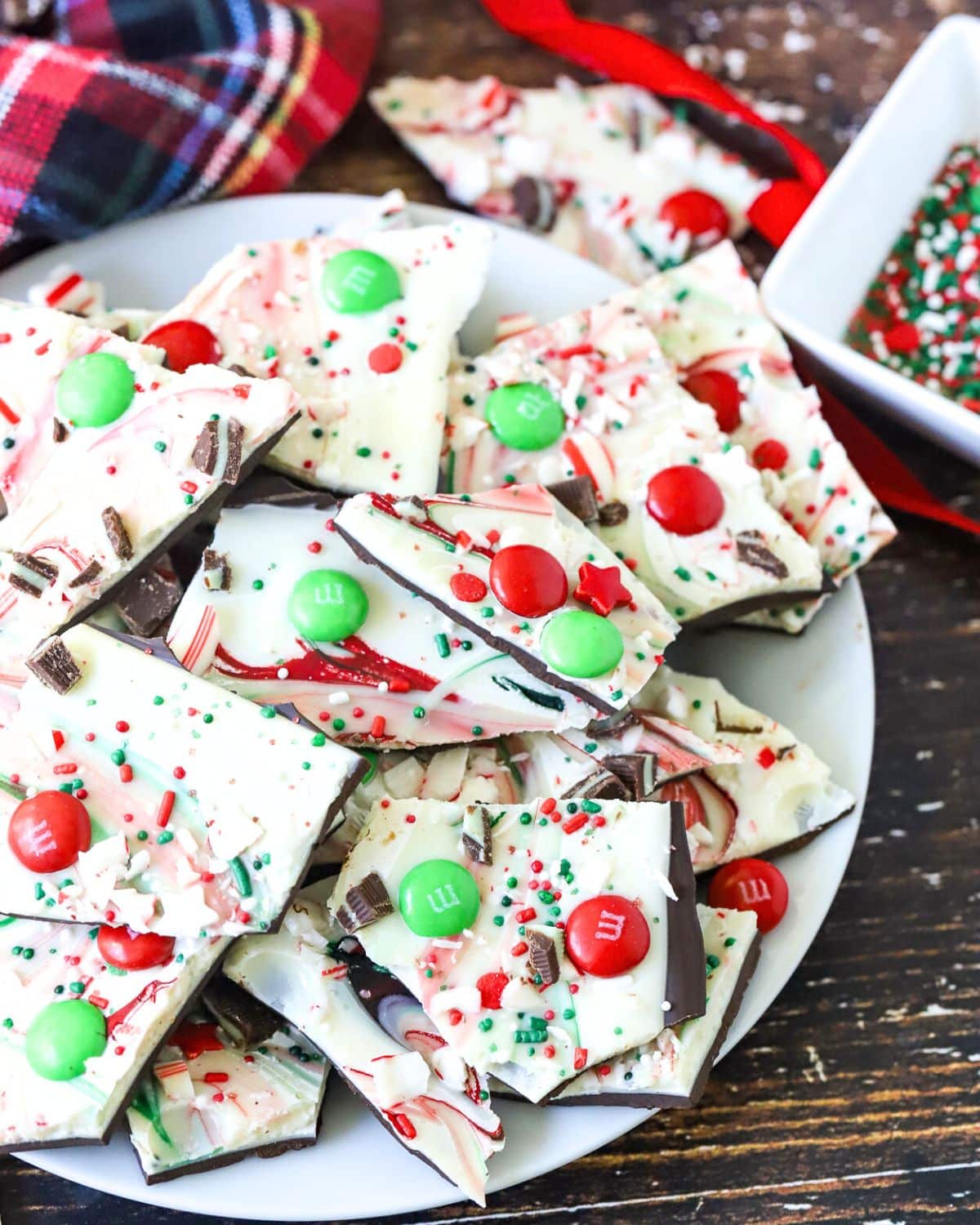 Chocolate Bark decorated in Christmas colors on a plate.