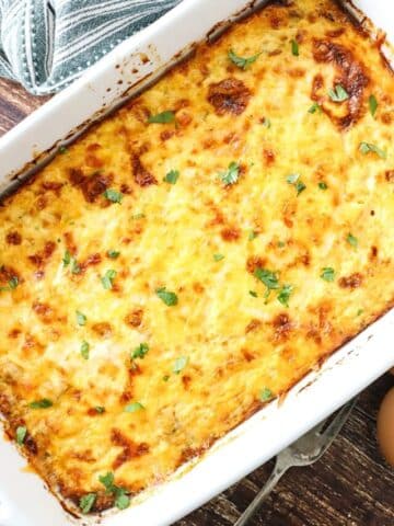 A freshly baked Italian sausage casserole in a white baking dish.