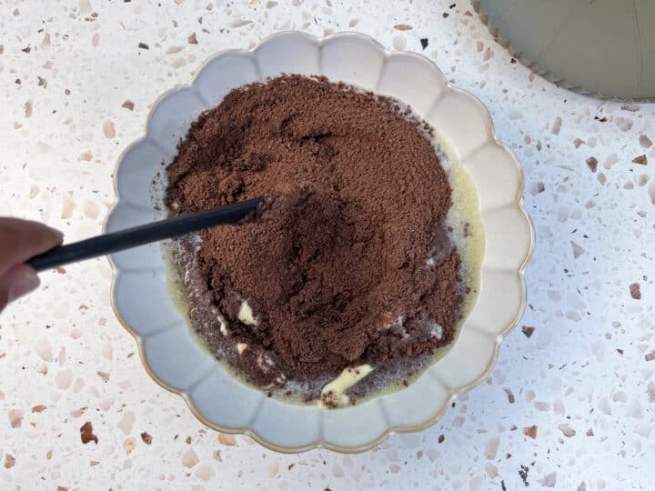 Butter and chocolate graham crackers being mixed together