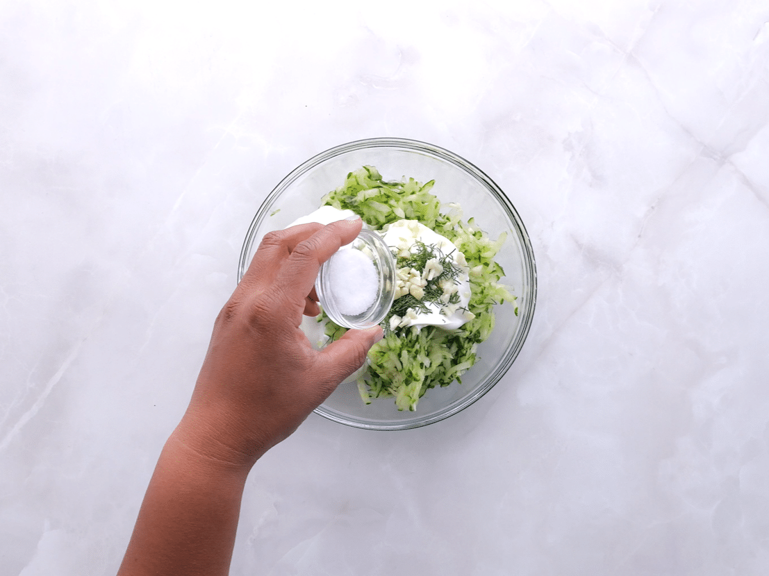 mixing ingredients for tzatziki sauce