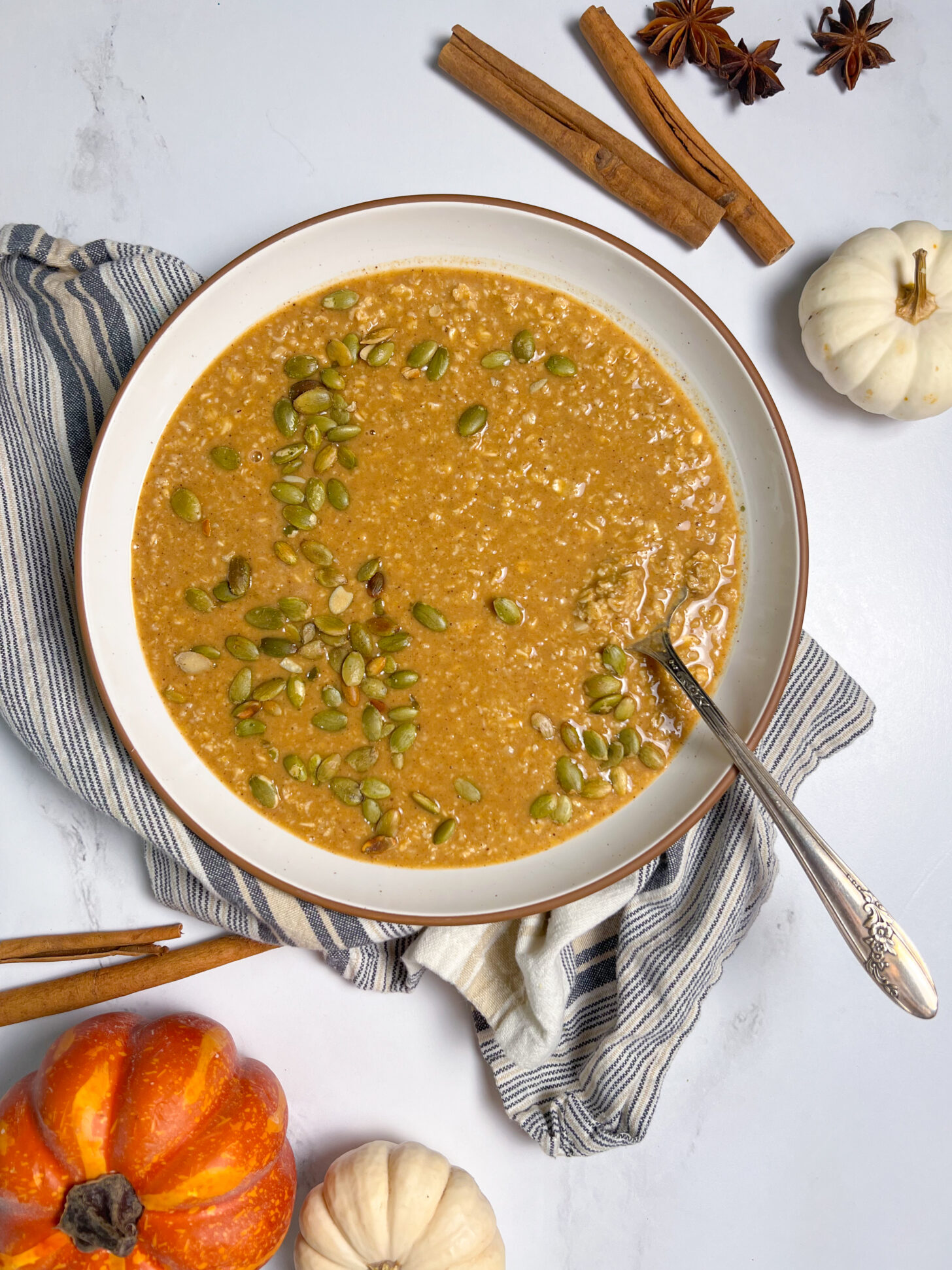 Pumpkin Spice Crock Pot Oatmeal in a bowl topped with pepitas