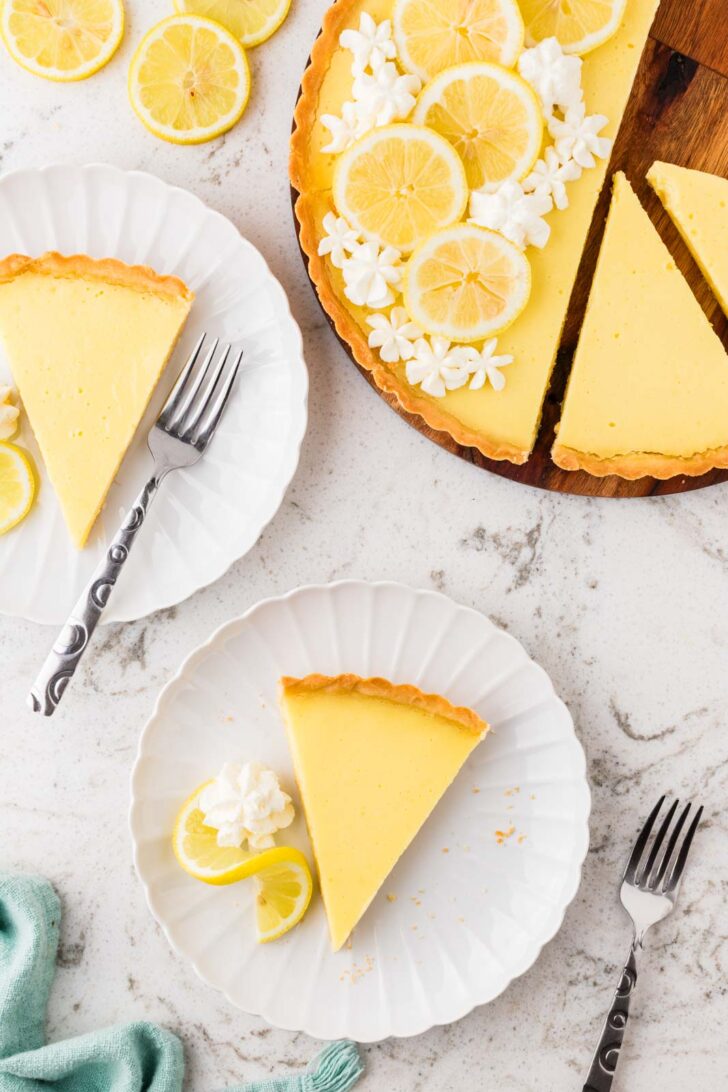 Lemon tart slices next to full lemon tart